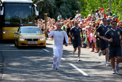 Torchbearer 071 Ray Morgan carries the Olympic Flame on the Torch Relay leg between Blaenavon and Pontypool.