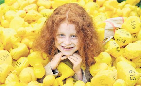 TOTALLY QUACKERS: Lilli Edwards, seven, helps with the launch of the Tintern Jubilee duck race.
More than 1,000 plastic ducks raced down the river from Brockweir Bridge with the race ending opposite
the Rose and Crown in Tintern. The 12 prizes included 