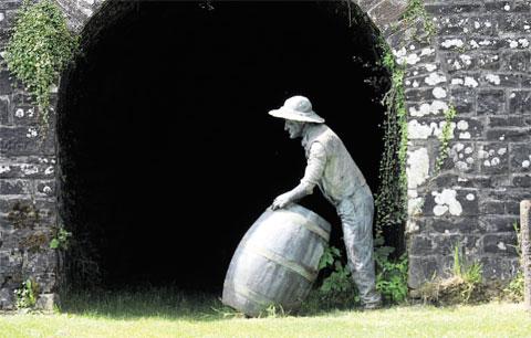 DOUBLE TAKE: At first glance, this gentlemen looks like he’s rolling out the barrel but it’s actually a
sculpture at Goytre Wharf Picture: MARK LEWIS WL_10297