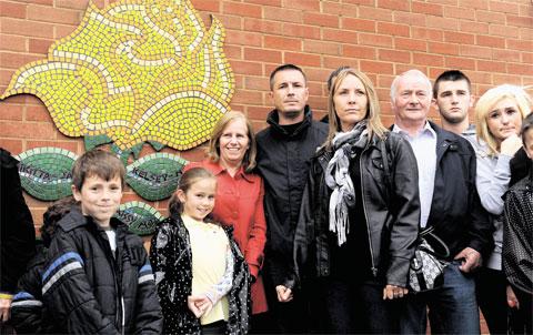 UNVEILED: Nikitta Grender’s boyfriend Ryan Mayes, second right, and her parents Paul Brunnock and Marcia Grender, centre holding hands, at the memorial unveiled to remember Nikitta, her baby Kelsey May and the family pet at the Newport East Community Ce