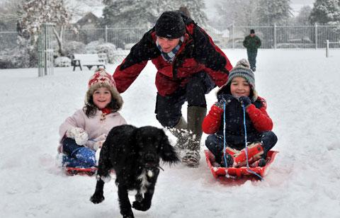 Holly, 4, and Lewis Webb, 6, enjoy some sledging in Bailey Park Abergavenny with their Dad Rod Webb.