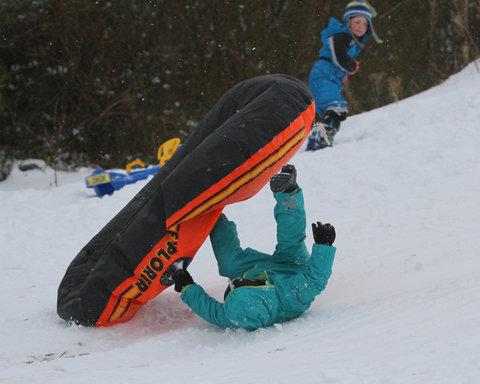 A Brynithel youngster takes a tumble in his dinghy whilst playing in the snow