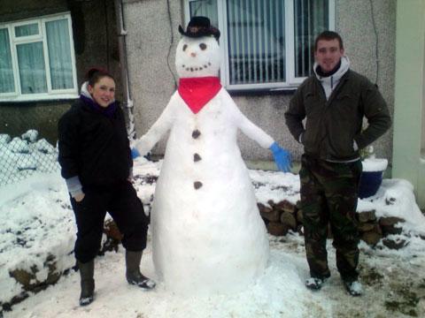 Jess and Craig with their snowman in Pontypool.