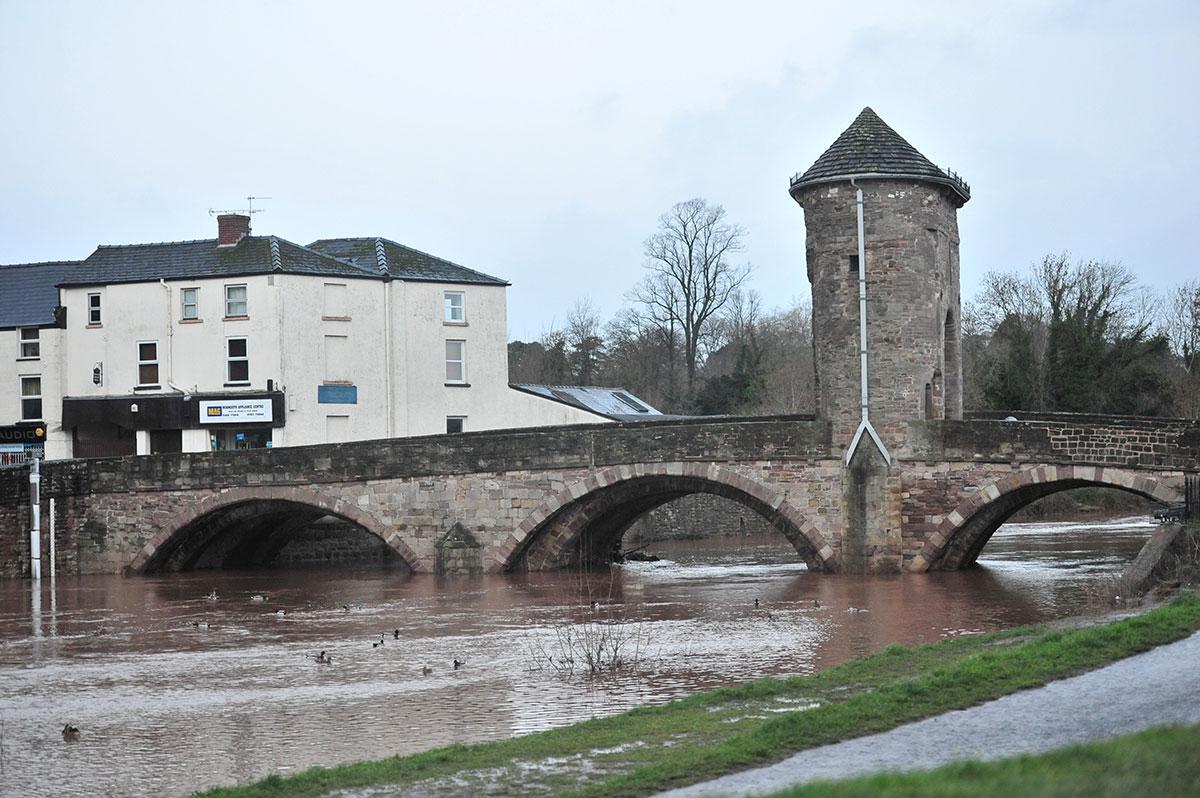 High water flows under the Monnow Bridge in Monmouth. Pic by Michael Eden.