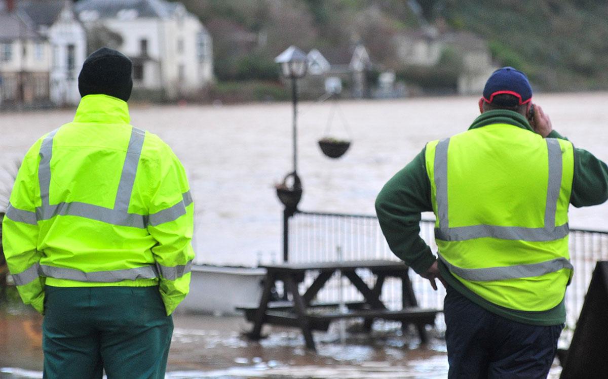 Council workers survey the flood waters at Tintern as they begin to recede. Pic by Michael Eden.
