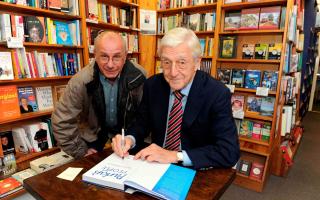 Sir Michael signing a copy of his book at Chepstow Bookshop for Darrell Mills