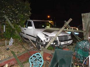 Car crashes through garden fence