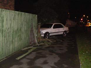 Car crashes through garden fence