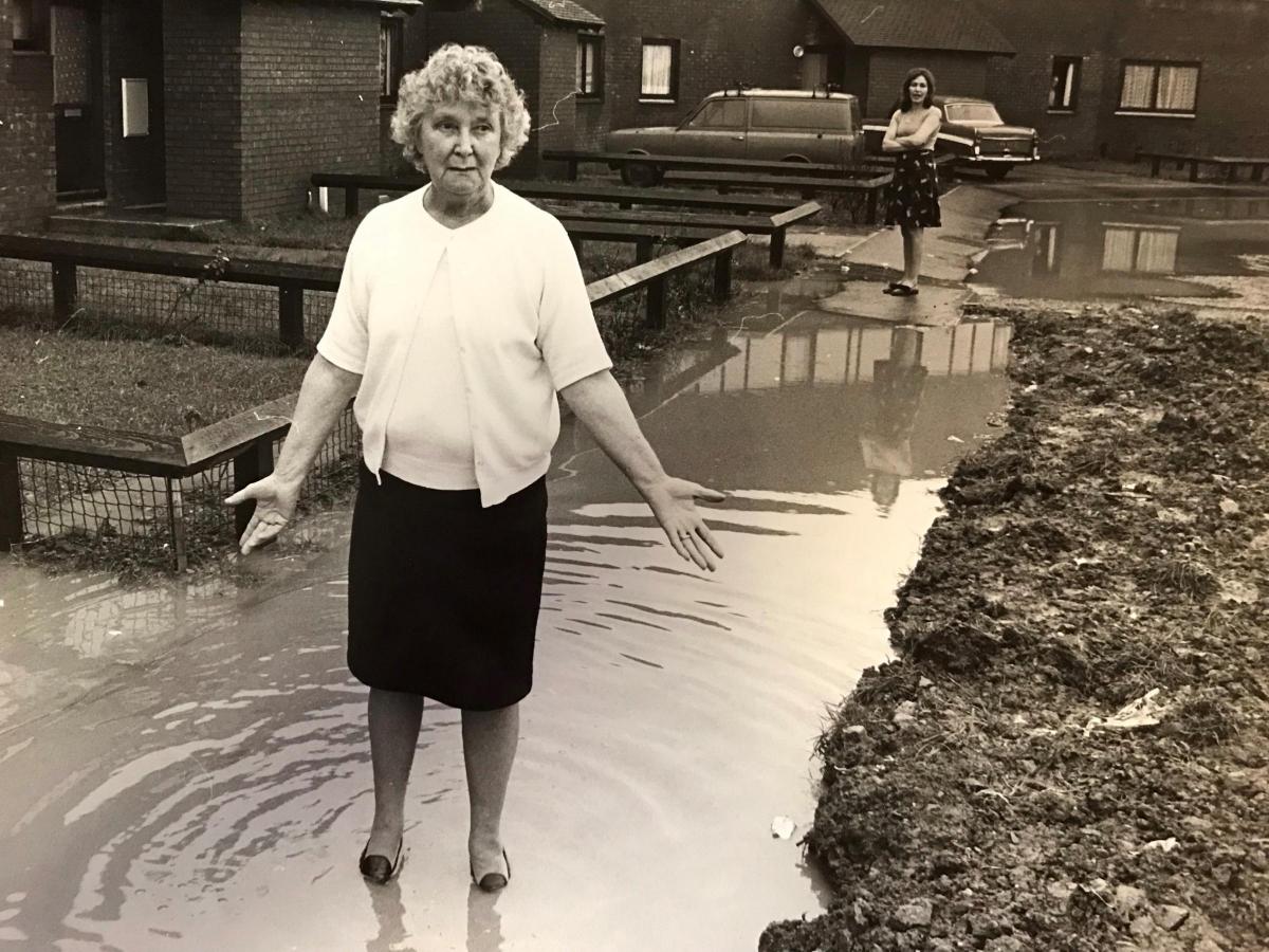 Mrs Vera Pewtner had to wade through a giant puddle every time she left her house in Sandpiper Way, Newport, 1979