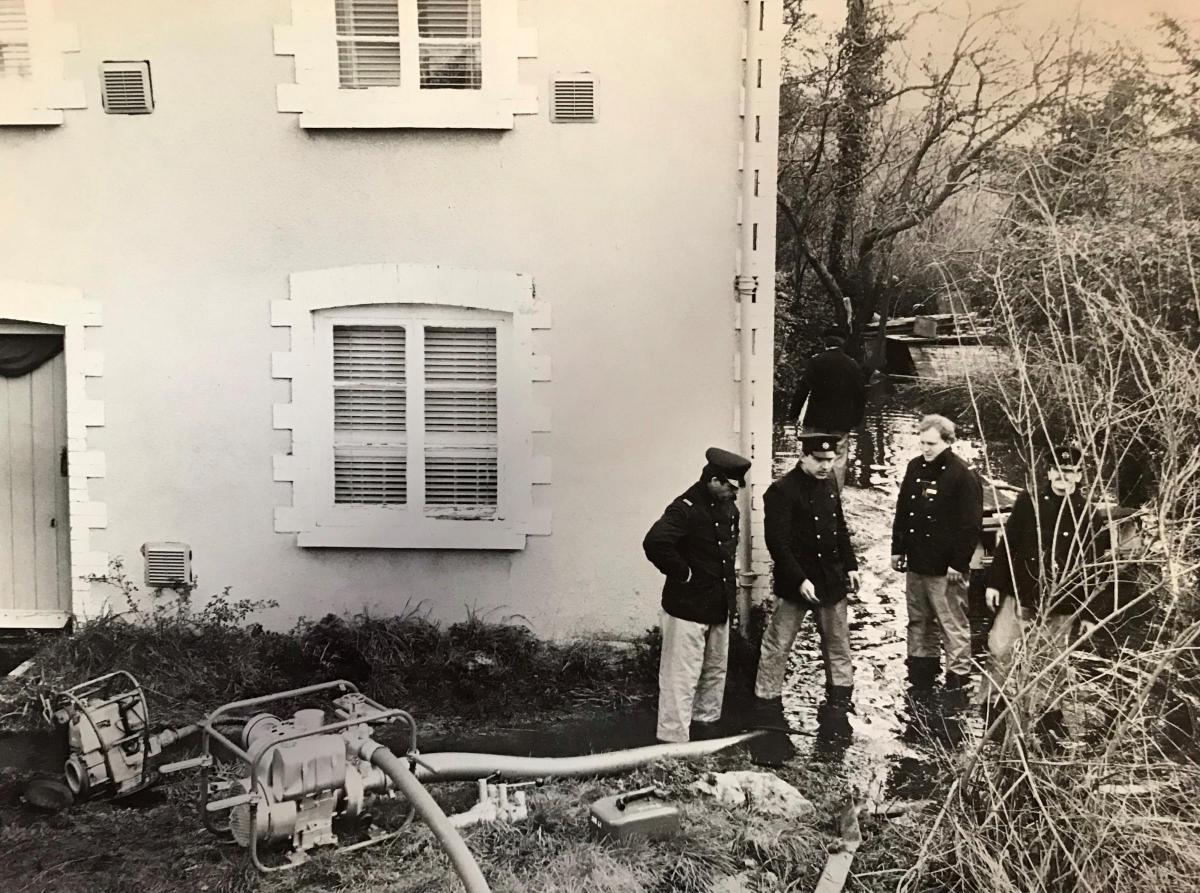 Firemen from Duffryn fire station, Newport, pumping water from the cottage in The Dingle, Maesglas Grove, in 1981