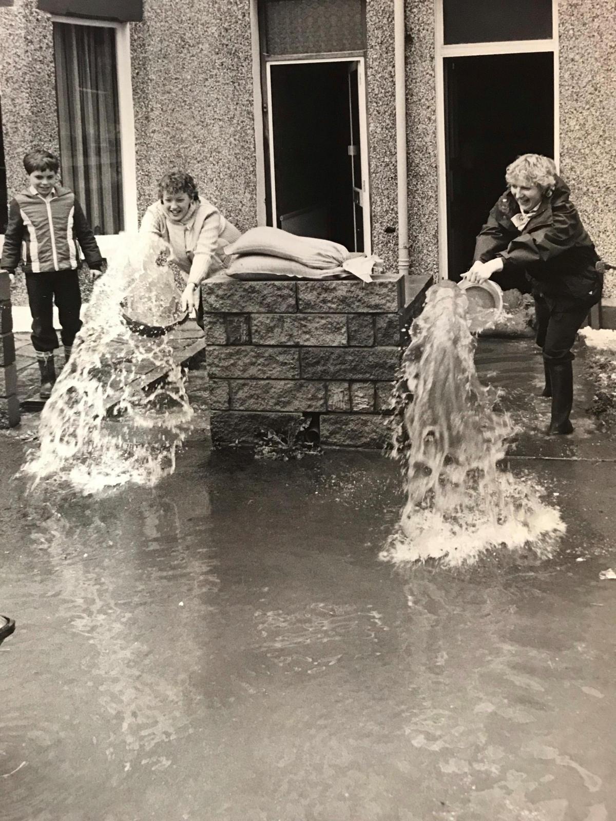 Rsidents of Old Kimberley Terrace, off Malpas Rpad, clean up their homes after thunder storms flood the street and houses in 1983