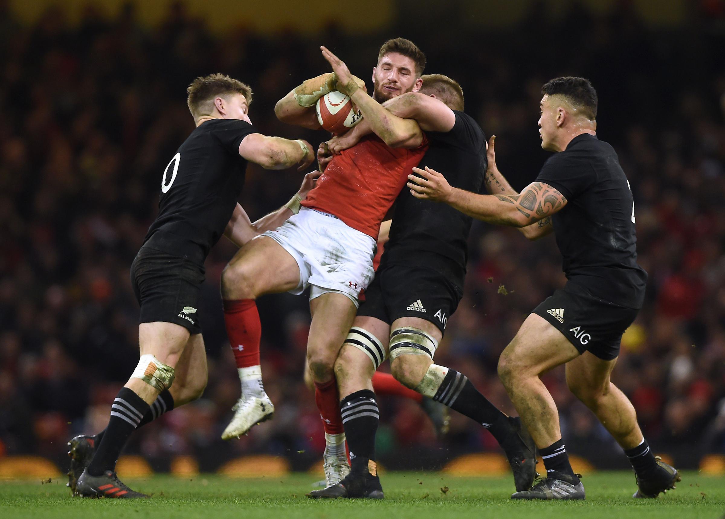 Wales Owen Williams is tackled by New Zealands Beauden Barrett, Sam Cane and Codie Taylor during the Autumn International at the Principality Stadium, Cardiff. PRESS ASSOCIATION Photo. Picture date: Saturday November 25, 2017. See PA story RUGBYU