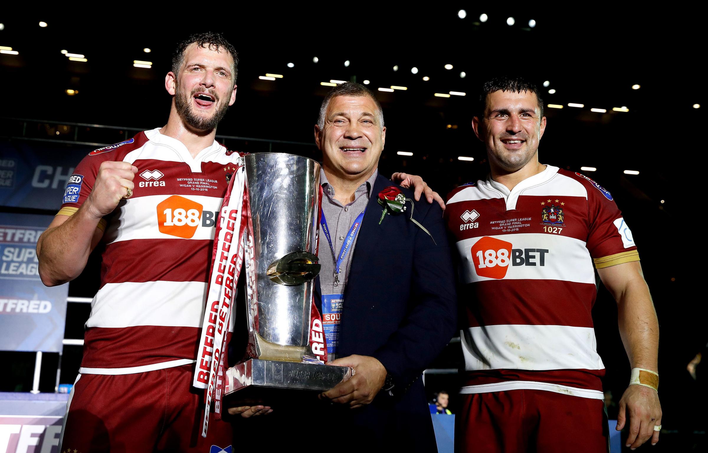 WINNERS: Wigan Warriors Sean OLoughlin (left), head coach Shaun Wane (centre) and Ben Flower (right) celebrate their 2018 title win