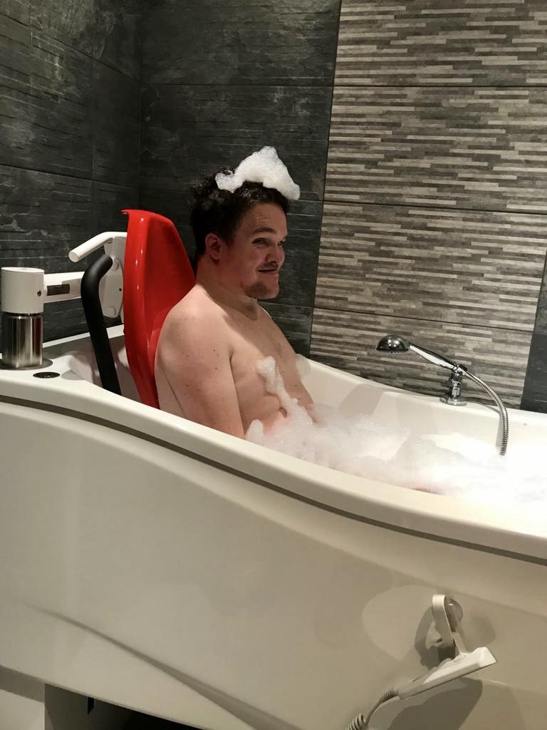 Aiden Stott loving his new specially-adapted bath. 