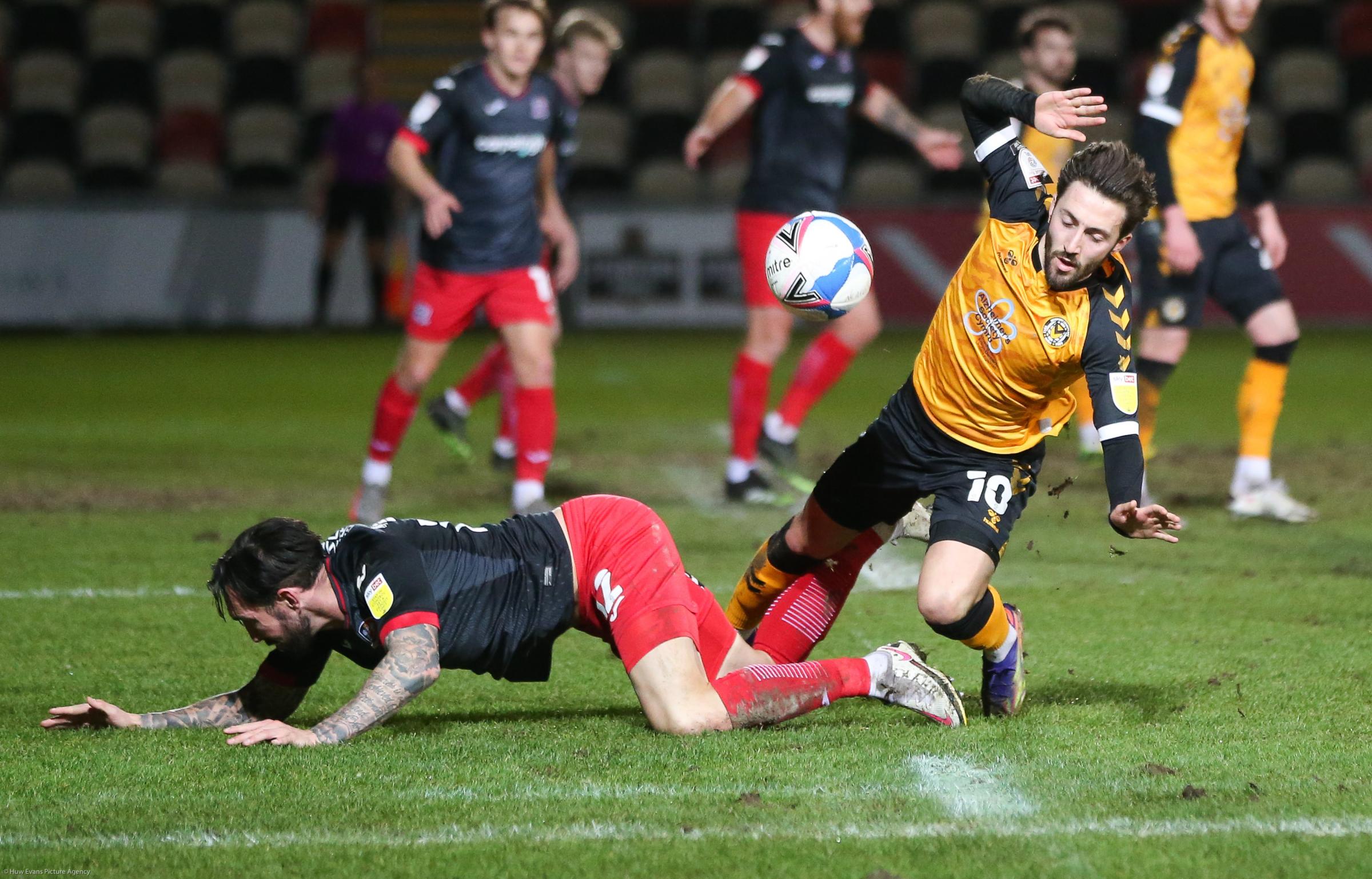 Newports Josh Sheehan battles for possession against Exeter