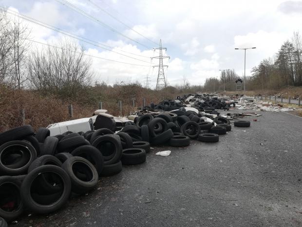 South Wales Argus: Hundreds of tyres are piled up on the unused road, where Newport City Council plans to install CCTV this month. Picture: The National