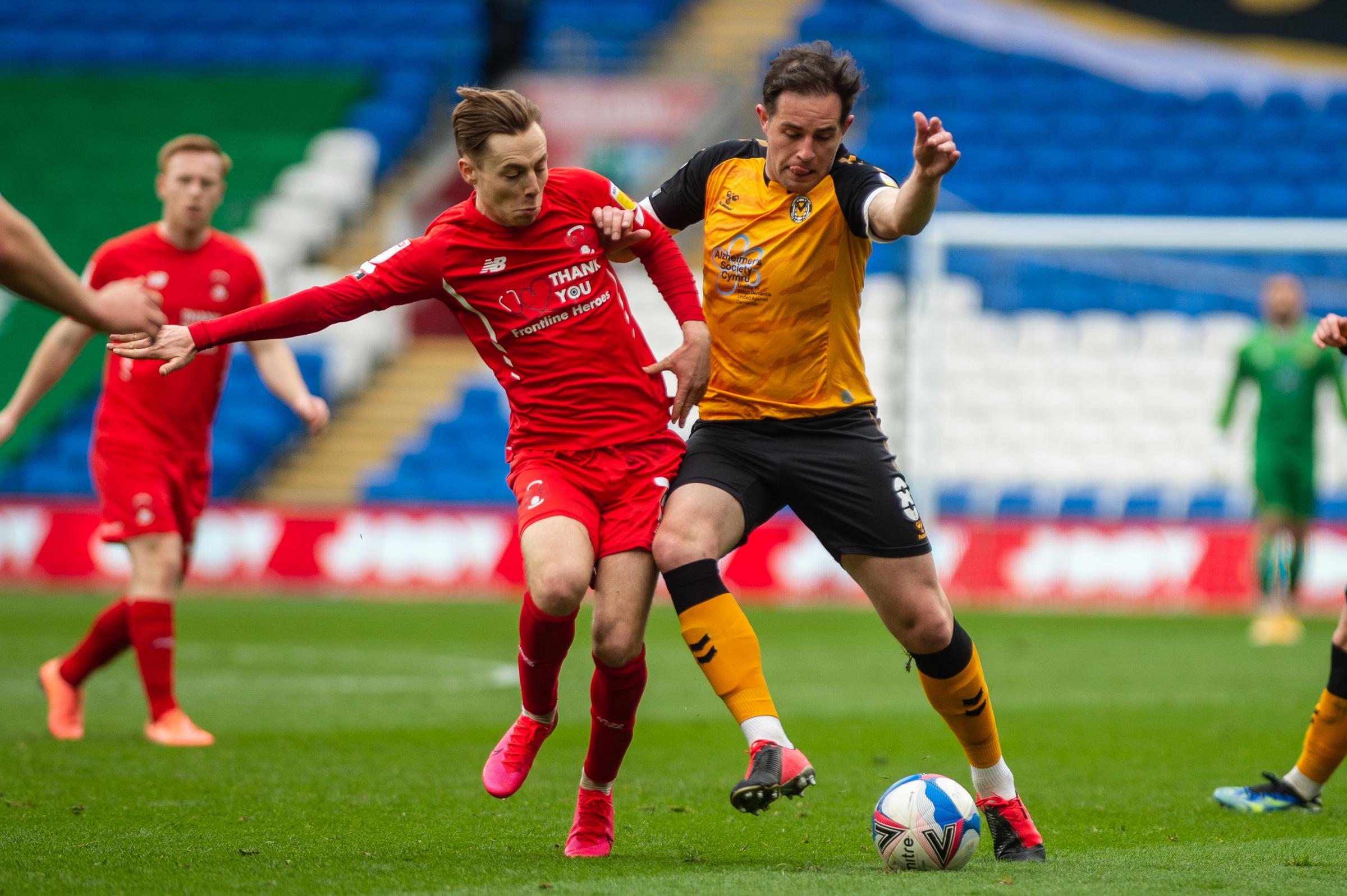 20.03.21 - Newport County v Leyton Orient - Sky Bet League 2 - Matthew Dolan of Newport County holds off Danny Johnson of Leyton Orient