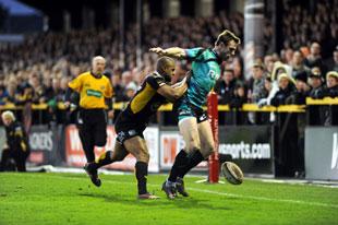 Ospreys Tommy Bowe and Aled Brew of the Dragons in action