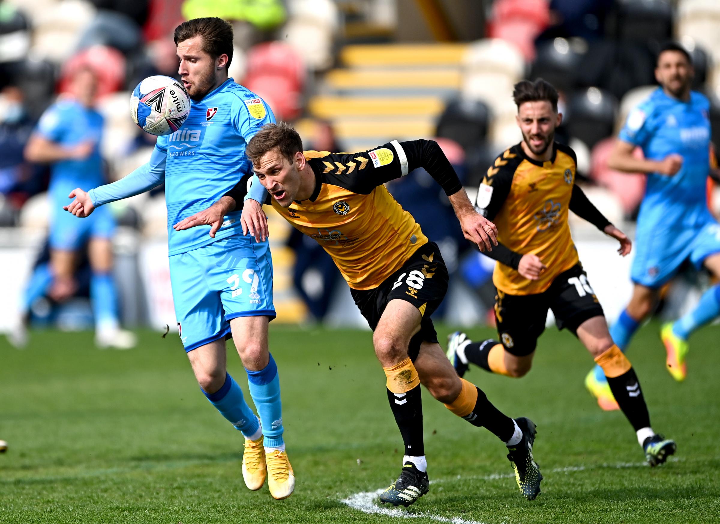 Newport Countys Mickey Demetriou (right) and Cheltenham Towns Indiana Vassilev battle for the ball during the Sky Bet League Two match at Rodney Parade
