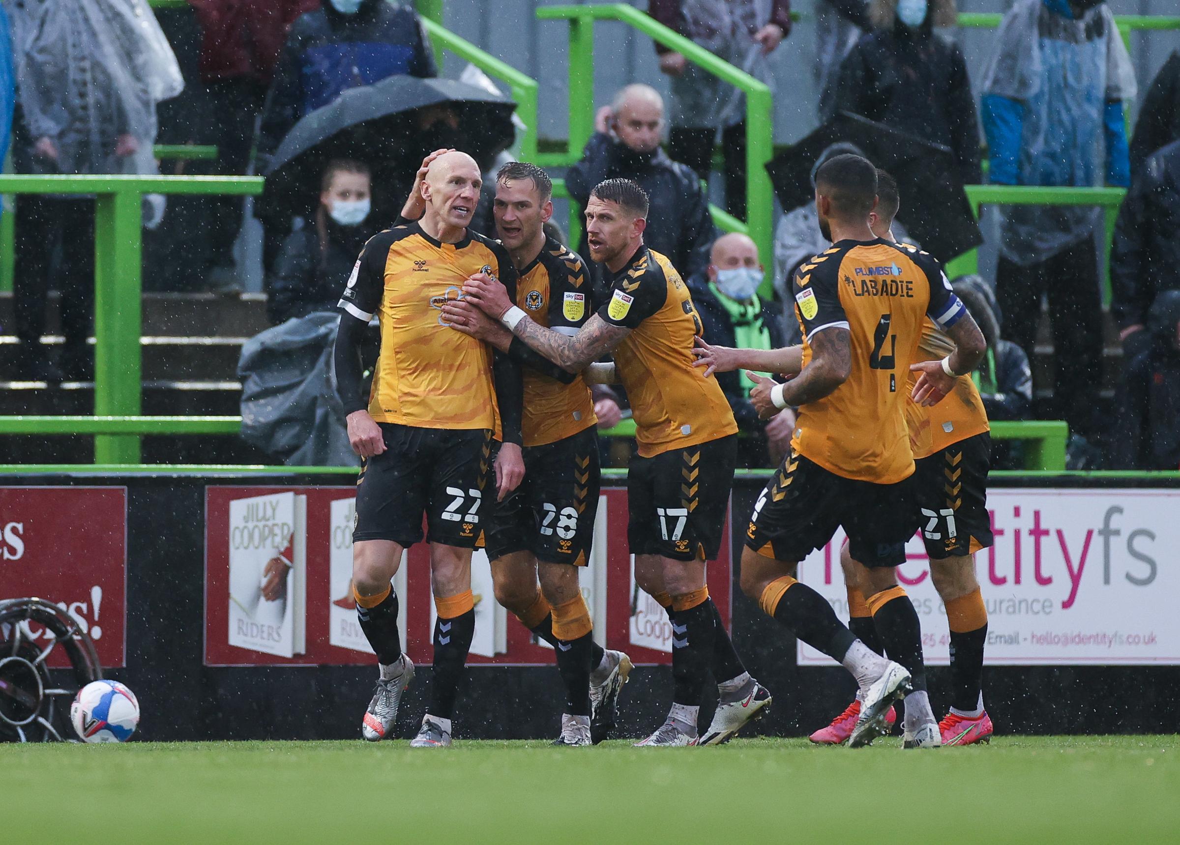 Kevin Ellison of Newport County wheels away to celebrate with team mates after scoring goal