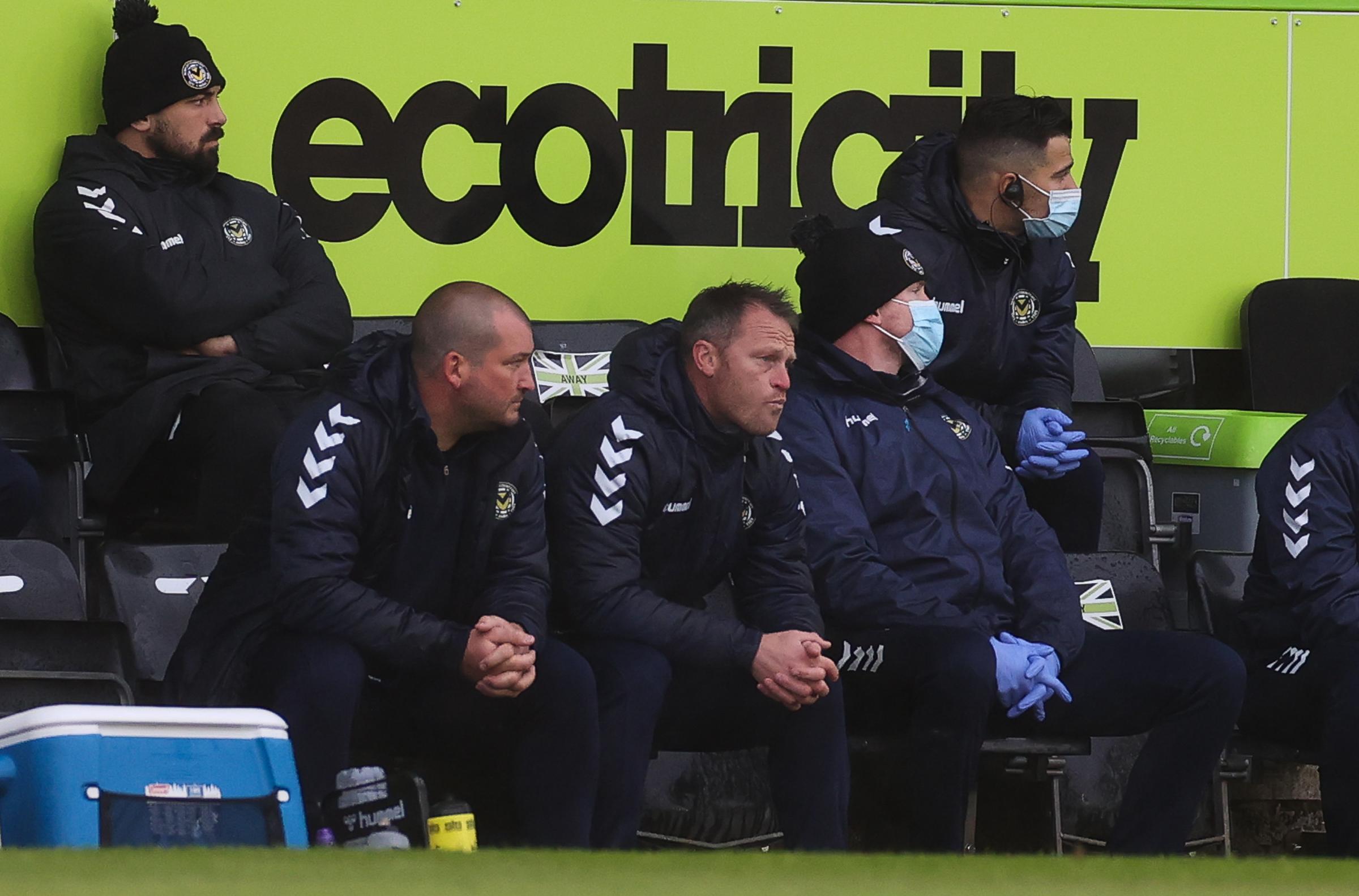 Newport County manager Michael Flynn and the backroom staff look on at Forest Green