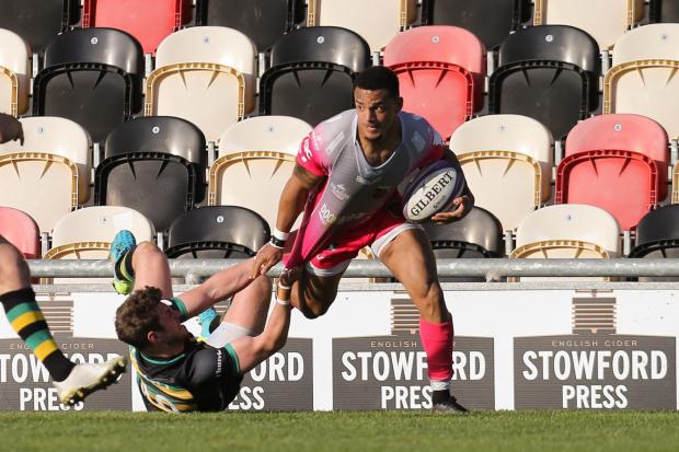 Ashton Hewitt of Dragons tries to get away from James Grayson of Northampton Saints. Picture: Huw Evans Picture Agency.