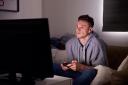 Young Man Addicted To Video Gaming At Home