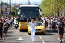 Torchbearer 074 Sarah Baker carries the Olympic Flame on the Torch Relay leg through Newport.