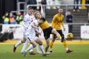 BATTLE: Will Evans fights for possession for Newport County against MK Dons