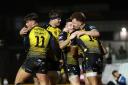 JOY: The Dragons celebrate Rio Dyer's clincer against the Ospreys