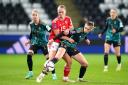 TUSSLE: Wales' Elise Hughes (centre) and Germany's Jule Brand battle for the ball