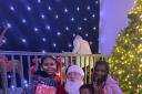 Children at NYCA with Santa and gifts