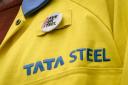 A steel worker wearing a badge on his jacket outside the UK's largest steel works in Port Talbot