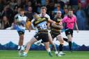 Dragons centre Jack Dixon carries hard against Wasps