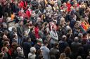 People stand for a minute of silence at the Gare de Lyon train station in Paris, Monday Nov. 16, 2015, three days after the Paris attacks.  A minute of silence was observed throughout the country in memory of the victims  of the country's deadliest