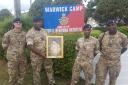 SUPPORT: Soldiers from the Royal Bermuda Regiment with a painting of Newport boxer David Pearce at Warwick Camp on the island