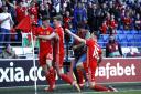 VICTORY: Goal scorer Daniel James, left, celebrates with Wales teammates David Brooks, centre, and Harry Wilson on Sunday