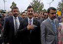 Newly elected lawmaker Yusuf Raza Gilani, centre, arrives at the opening session of Parliament (Anjum Naveed/AP)