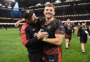 FIRST: Ceri Jones celebrates with Elliot Dee after the Dragons' first Judgement Day win