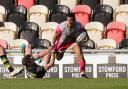 Ashton Hewitt of Dragons tries to get away from James Grayson of Northampton Saints. Picture: Huw Evans Picture Agency.