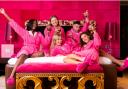 Women posing in pink hotel room. Credit: Hotelcs.com