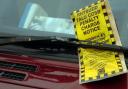 Stock image of a parking fine on a car windscreen.