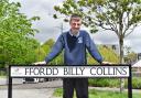 Ciaran Mitchel-Neal with the street sign named after Billy Collins