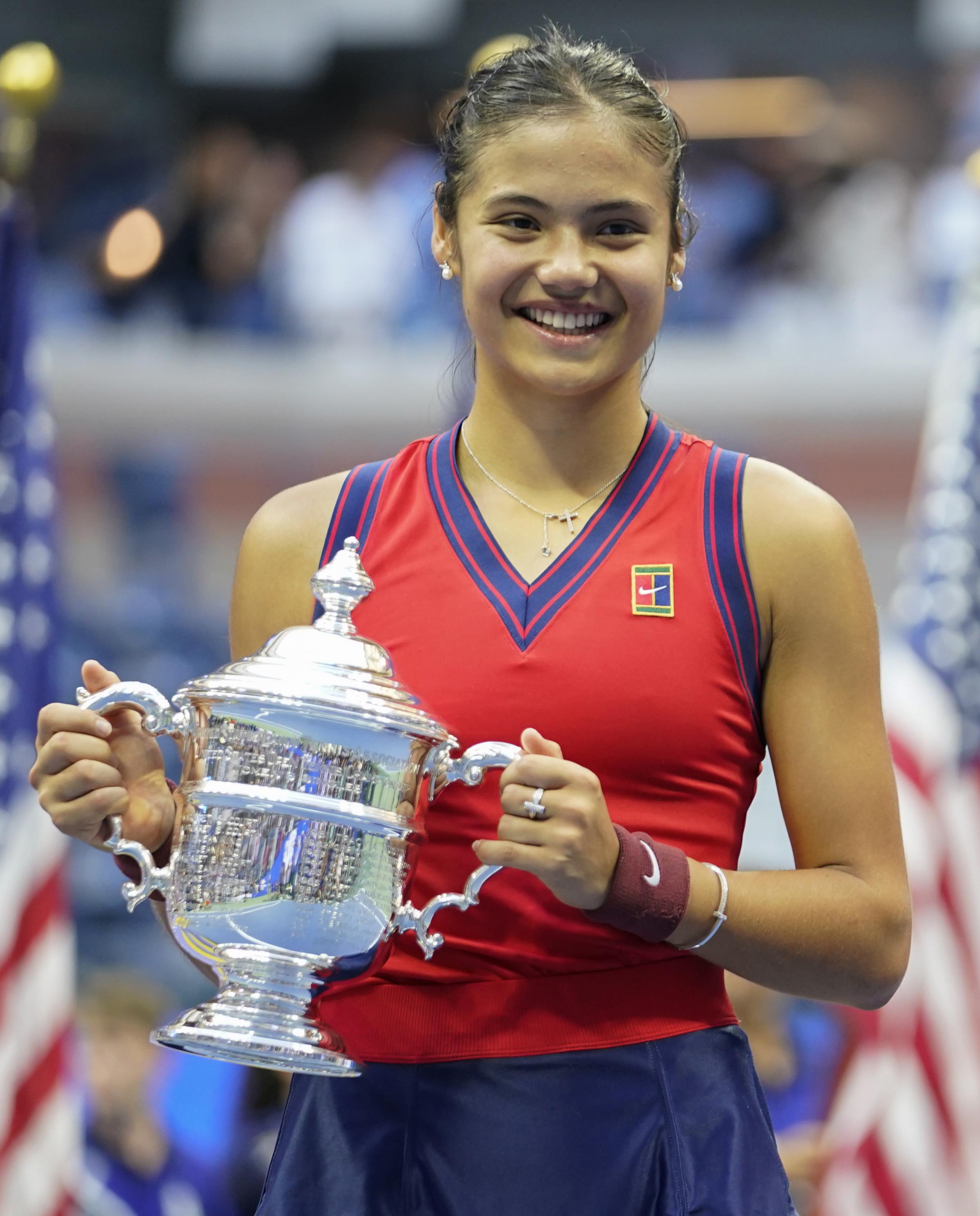 Great Britains Emma Raducanu holds the trophy as she celebrates winning the womens singles final on day twelve of the US Open at the USTA Billie Jean King National Tennis Center, Flushing Meadows- Corona Park, New York. Picture date: Saturday