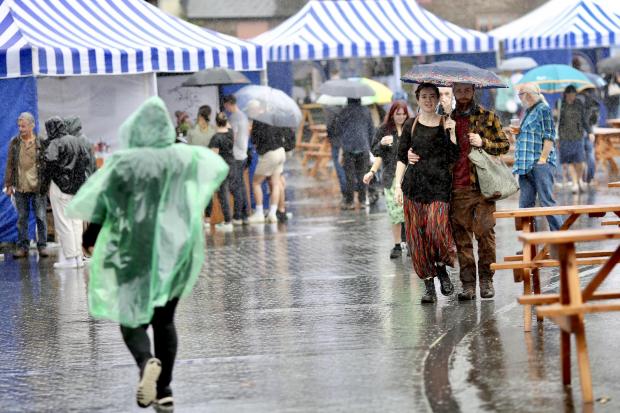 South Wales Argus: Heavy shower in the Brewrey Yard near the Market Hall. Credit: Peter Rhys Williams 