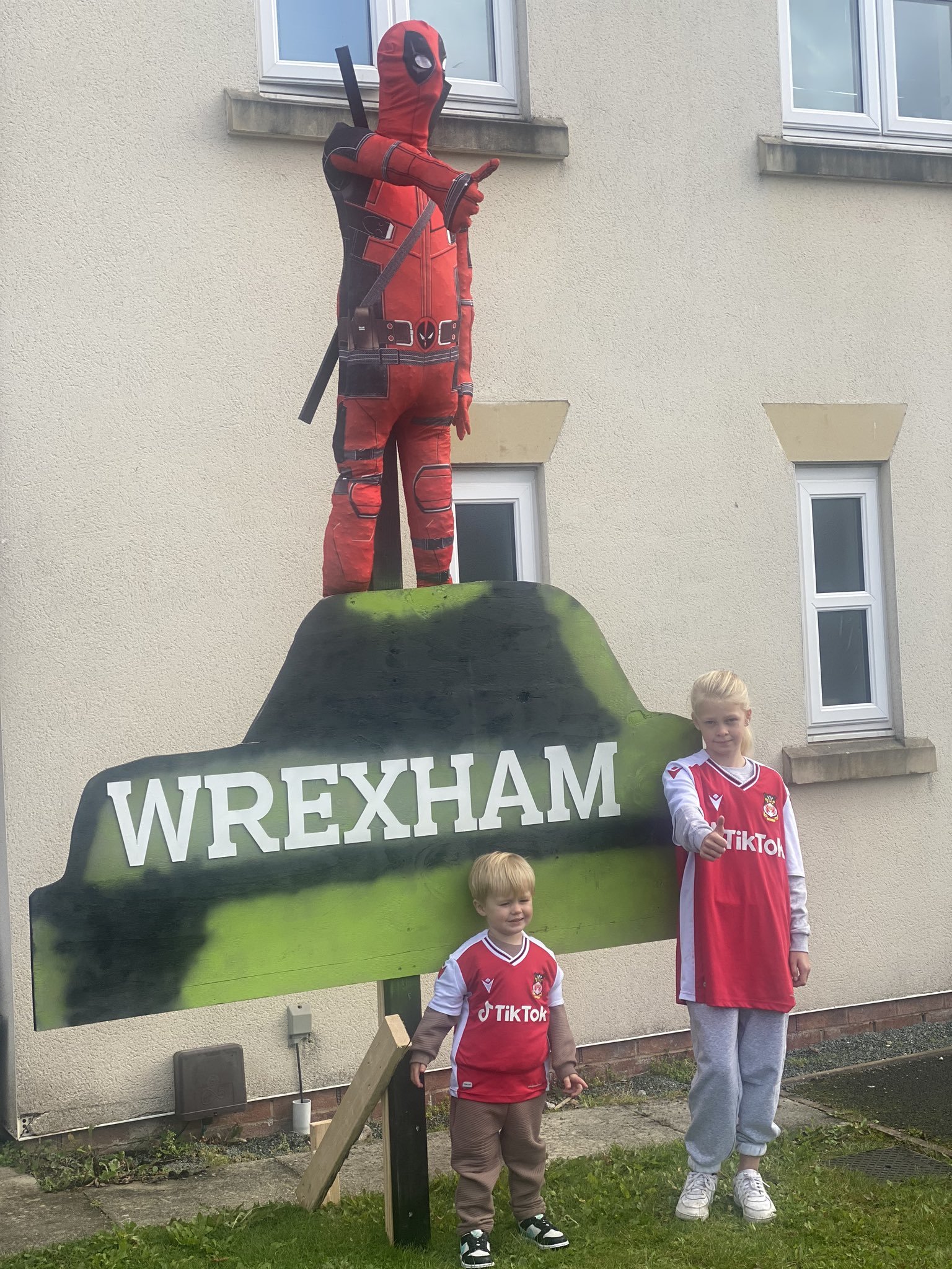 Ellie and Arthur, 11 and 13, posed for a photo with the straw Deadpool. Image: Leanne Gibbons/Twitter