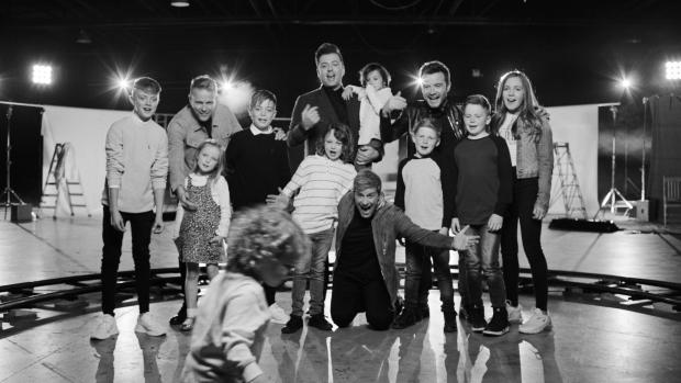 South Wales Argus: Westlife Shane Filan (third right), Markus Feehily (centre), Kian Egan (kneeling) and Nicky Byrne (second left) with their children appearing in the video for Westlife's single My Blood (PA)
