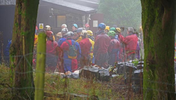 South Wales Argus: Rescuers near Penwyllt, Powys in the Brecon Beacons, Wales, where a rescue mission is underway to save a man who has been trapped inside a cave in the Ogof Ffynnon Ddu cave system. Credit: PA