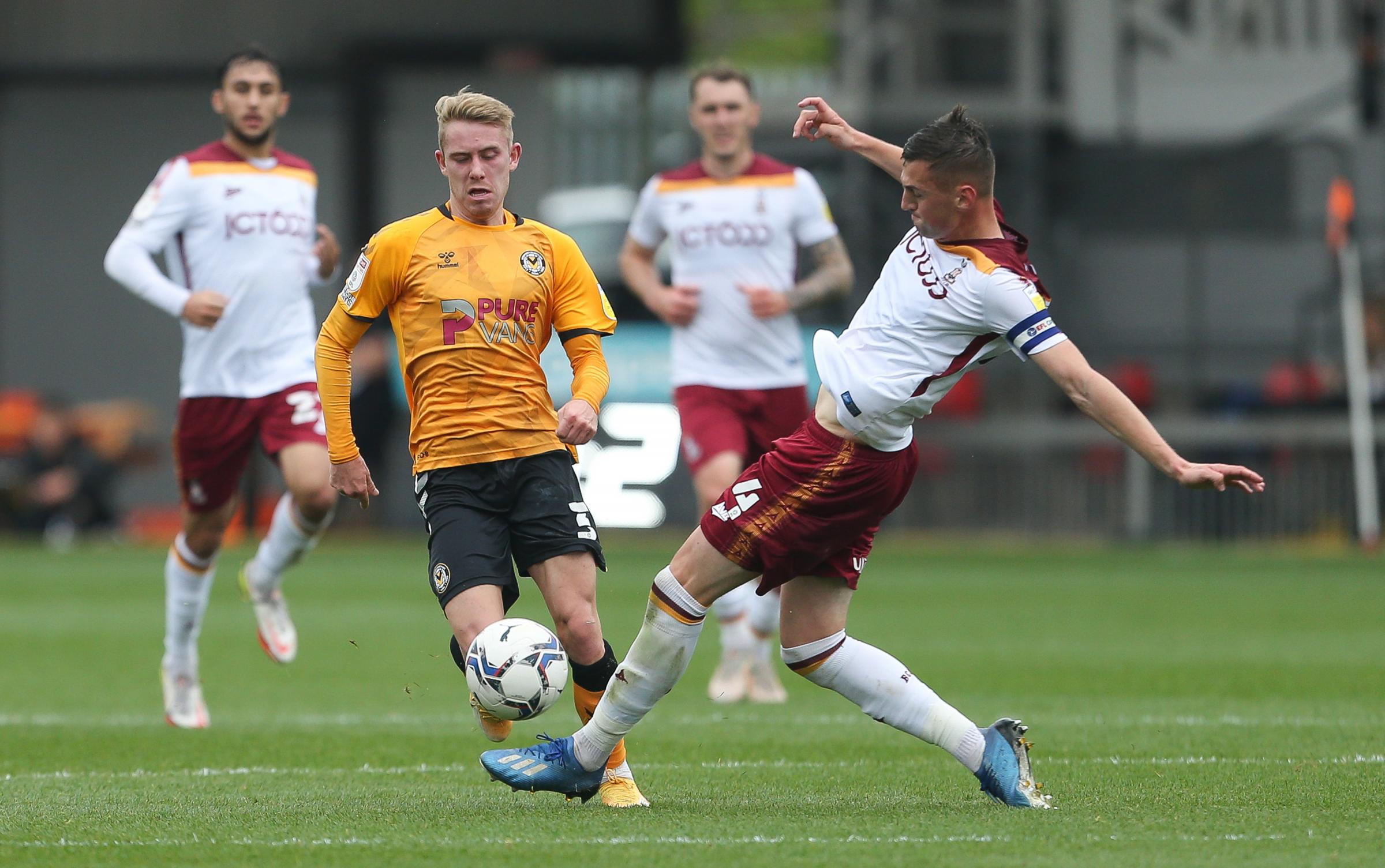 Ollie Cooper of Newport County is brought down by Paudie OConnor of Bradford City