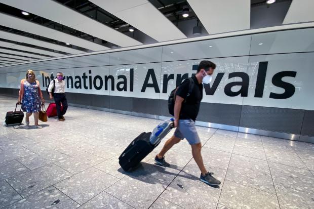 South Wales Argus: Passengers in the arrivals hall at Heathrow Airport Credit: Aaron Chown/PA